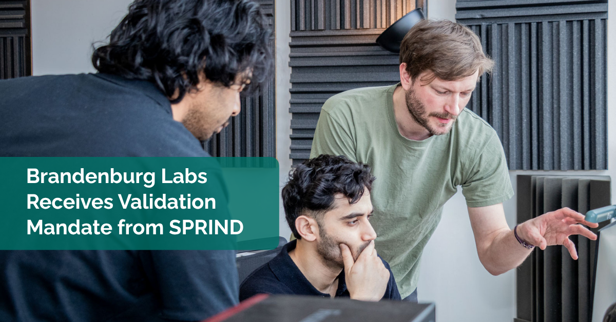 Sprind project Banner Three engineers discussing technical topics in an auditory lab